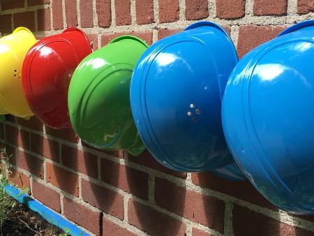 Helme (c) Karl Reinery/Pixabay Eine Reihe von Helmen hängt an einer Wand.